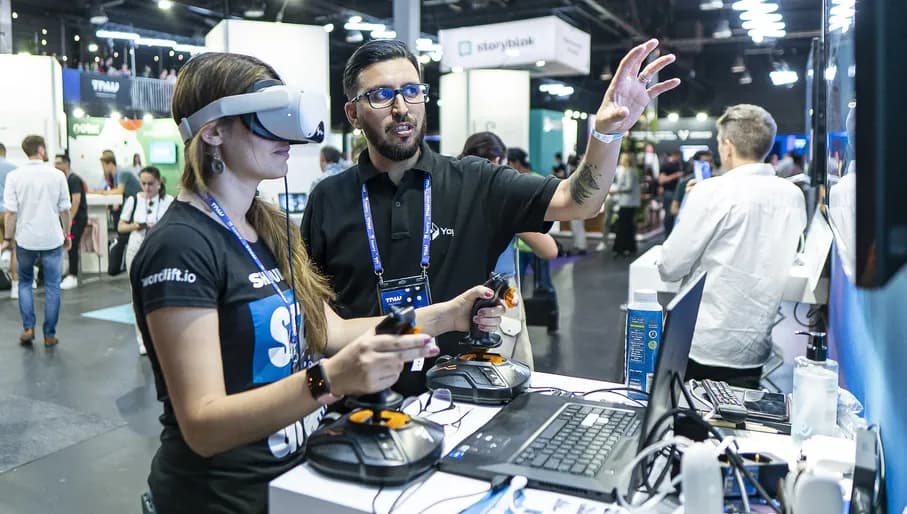 The Next Web conference exhibition.- woman wearing virtual reality glasses