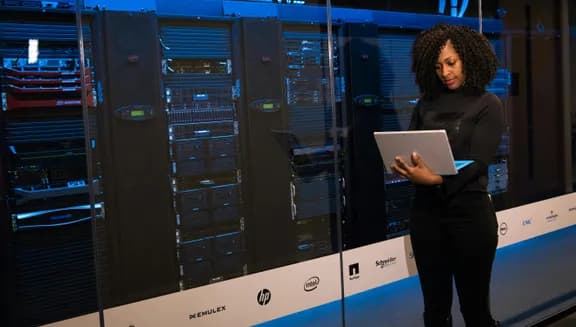 lady in front of large computing system with laptop