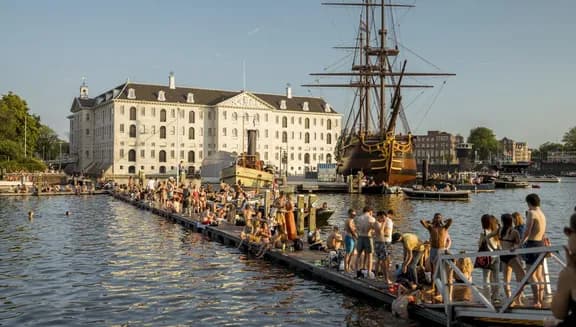 People swimming and sunbathing on the jetty at Marineterrein
