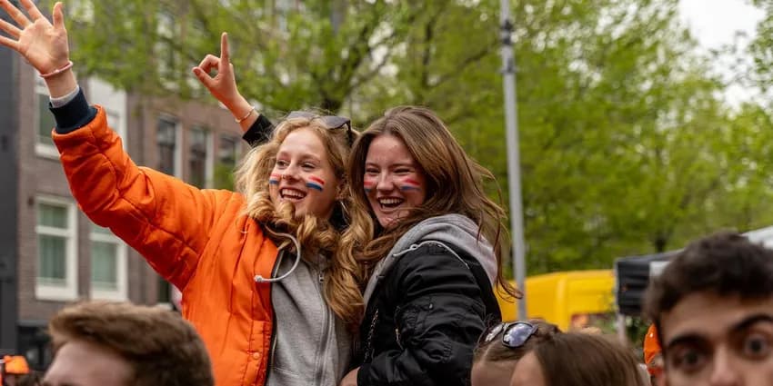 Two girls at Elandsgracht celebrating King's Day 2024.