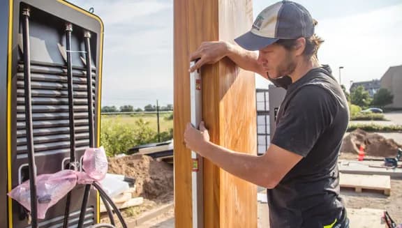Man measuring for new charging station for electric vehicles.