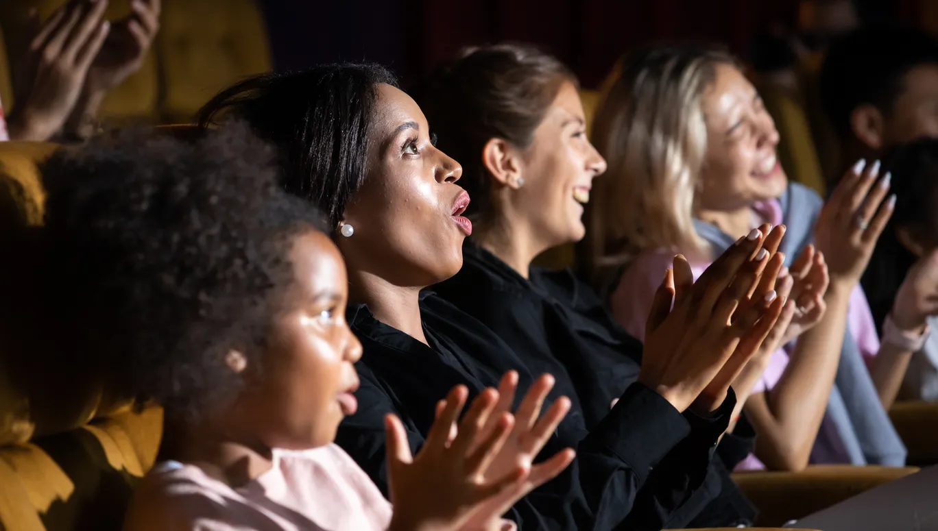 Group of diversity people watching movie in cinema theater with popcorn and drinks. Enjoy Happy laughing fun sad drama action movie concept.