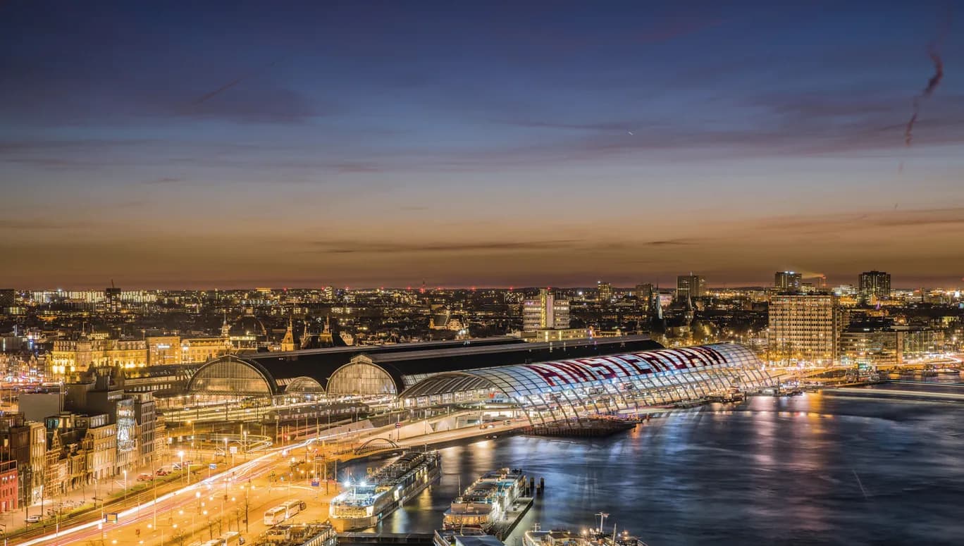 Amsterdam Central Train Station by the water.