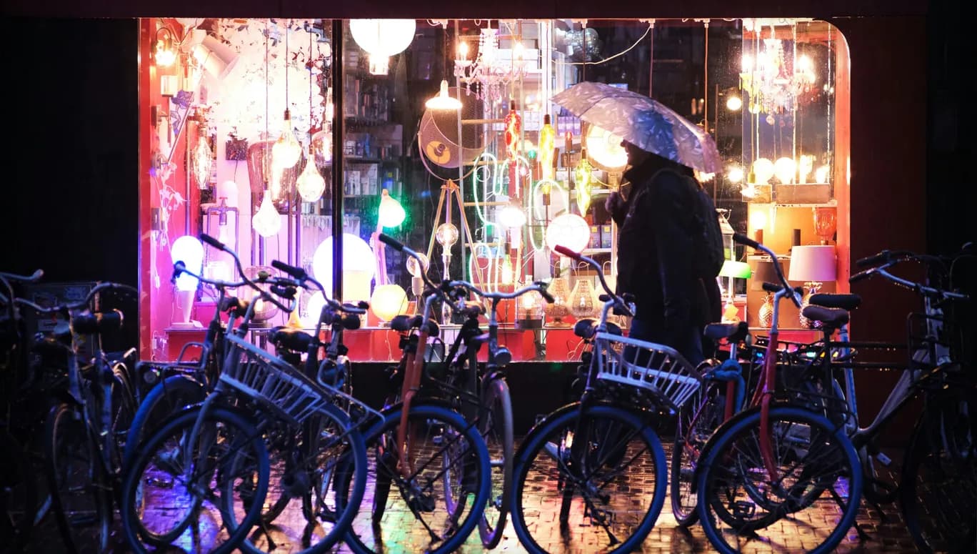 man in rain by bikes
