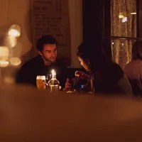 Couple dining in romantic candlelight at Smelt cheese fondue restaurant