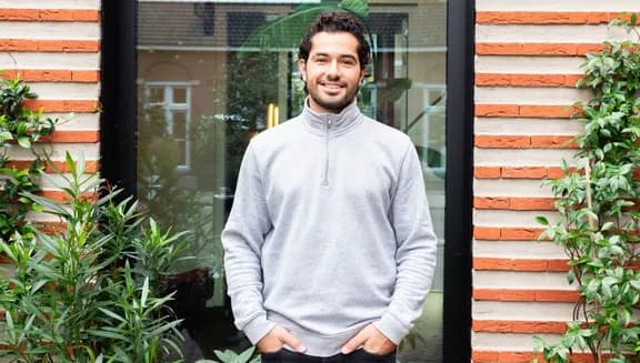 Portrait of Konstantinos Kouzelis, founder of Greencast, standing outside a building