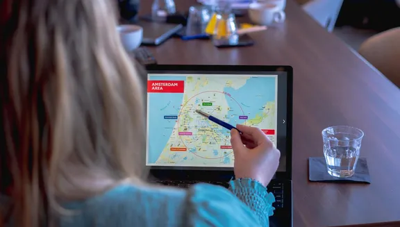 Woman pointing out something on her laptop.