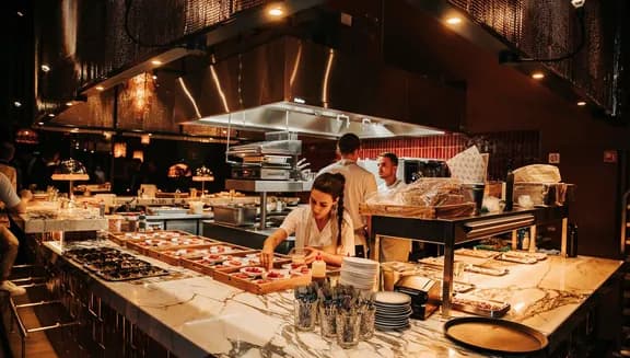 Chef preparing dishes at Hasta la Vista, Baby Spanish rooftop sky bar restaurant in Zuidas