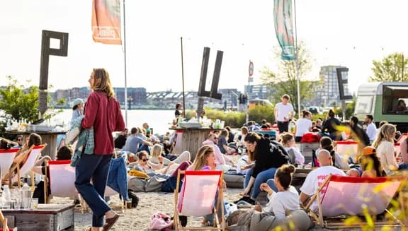 People chilling on the city beach of Pllek