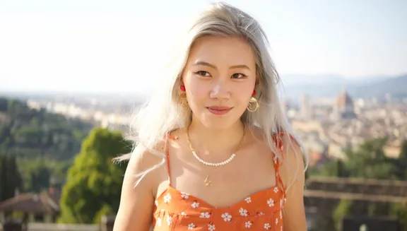 KOSA co-founder Layla Li outside with sunny cityscape in background.