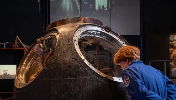 boy looking at astronaut exposition