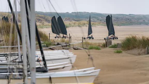 Boats in the sand and blowcarters at IJmuiderslag beach.