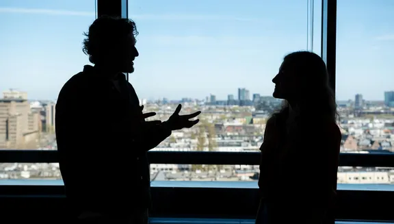 Man and woman discussing business.