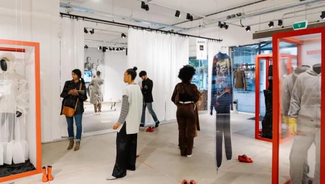 People looking at clothes at the  new normal gallery