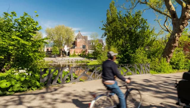 A person cycles through Oosterpark.