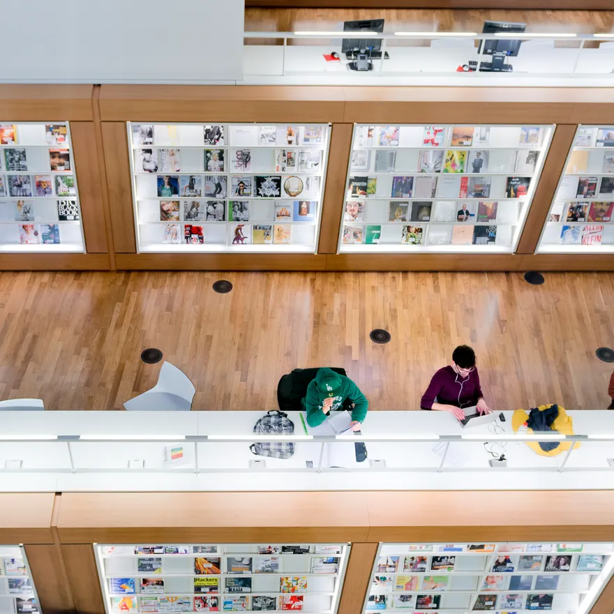 Amsterdam, the Netherlands - March 12, 2014: people, student are reading or working on the computers inside the modern central Public Library of Amsterdam, selected as best library of the Netherlands in 2012.