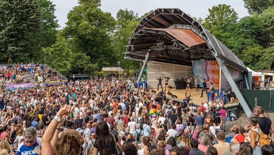 A crowd of people celebrating  at the pride park festival