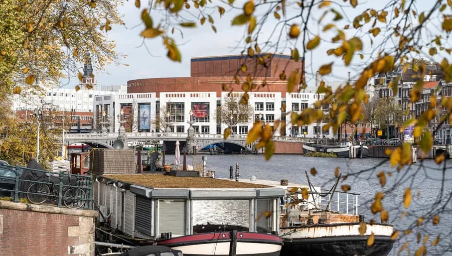 The National Opera & Ballet seen from a distance. This cultural institution is located at the Amstel river, close to Waterlooplein in the city centre.