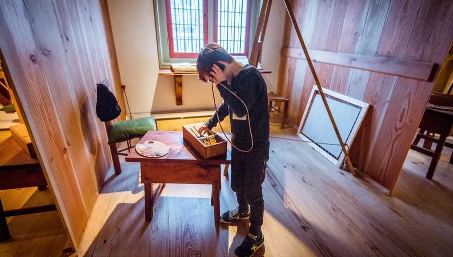 Kids holding an audio device to their ear