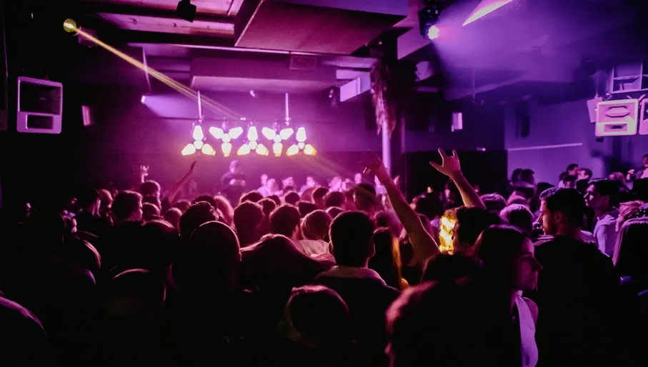 People dancing under the pink disco lights in nightclub Shelter.