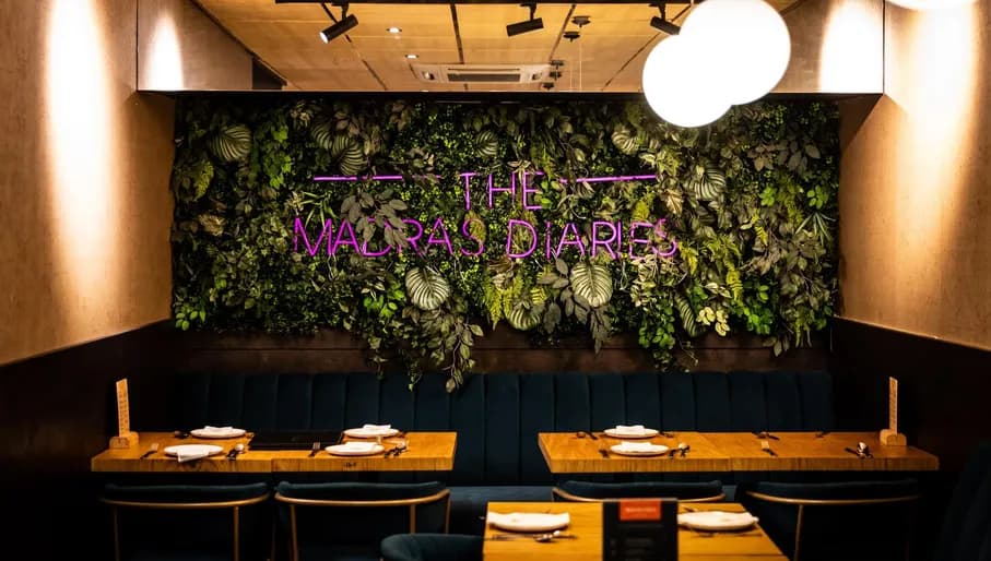 Neon interior and plant wall at The Madras Diaries Indian restaurant