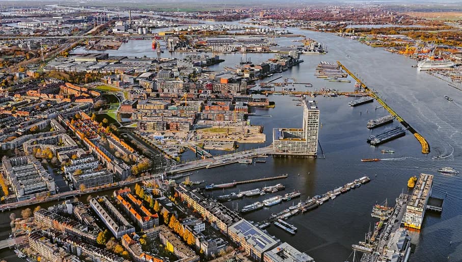 Het voormalig industrieterrein transformeert naar een woonwijk met ruim 2700 woningen en diverse voorzieningen. Met de nieuwe Houthaven wordt het water weer teruggebracht en ontstaan er zeven eilanden. 

Op elk eiland worden woningen gebouwd met een eigen karakter en architectuur, grenzend aan de nieuw te graven grachten en met een verbinding naar het IJ. Een nieuwe wijk die ook nog eens volledig klimaatneutraal wordt.

De woonwijk Houthaven ligt tussen de Spaarndammerbuurt en het IJ. Het ontwerpbestemmingsplan van de nieuwe Houthavens voorziet in woningen en bootbewoning in schepen en bestaat uit zeven autoluwe eilanden. Er komen volgens bureau stedelijke planning 2700 woningen. 

Er zijn veel ontwikkelaars betrokken bij de tot standkoning van Houthaven. Waaronder De Key, Rochdale en Ymere. Voor Narva-eiland en Mermei-eiland is is VORM een samenwerking aangegaan met BPD. Hierbinnen hebben Klunder architecten en Van Aken Architecten appartementencomplexen ontworpen.

De namen van de eilanden en de bruggen verwijzen naar de houthandel die Amsterdam dreef met diverse Europese steden. Het wordt een stadskwartier met smalle straatjes en veel water. Veel laagbouw en deel is voor sociale woningbouw en er wordt klimaatneutraal gebouwd. Foto John Gundlach.