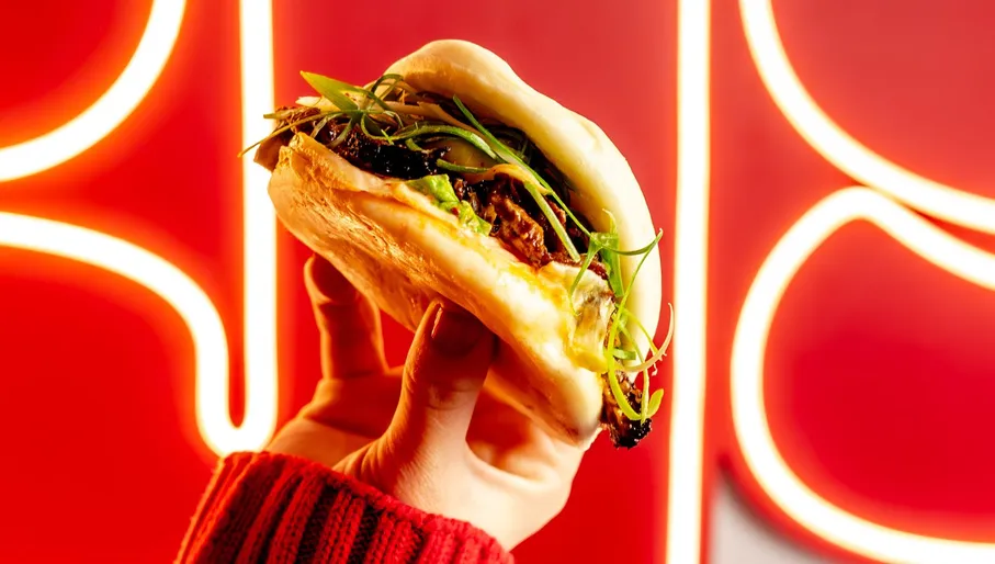 Larry's hand holding a signature bun