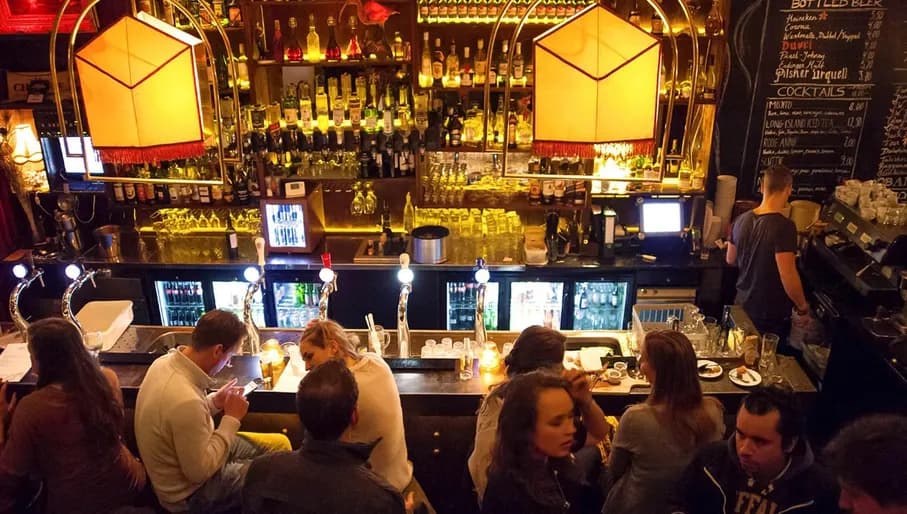 People sitting at the bar at Mata Hari De Wallen Red Light District