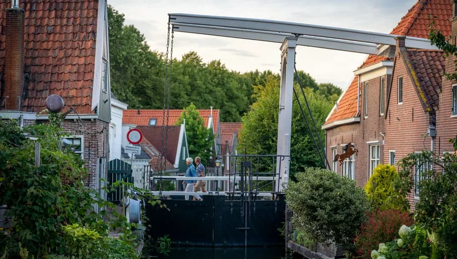 People walking over a bridge in Edam.