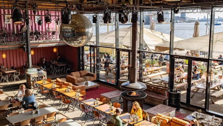 Pllek people sitting inside and out