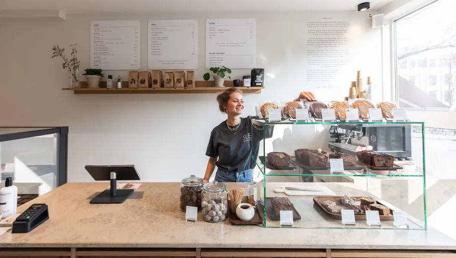 Woman serving pastries at SUE Bites Bar