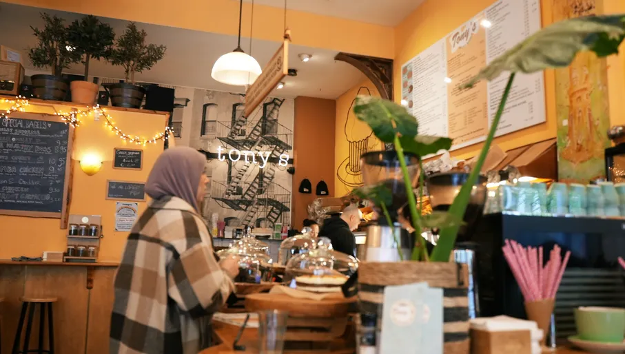 A woman ordering at Tony's New York City Bagels