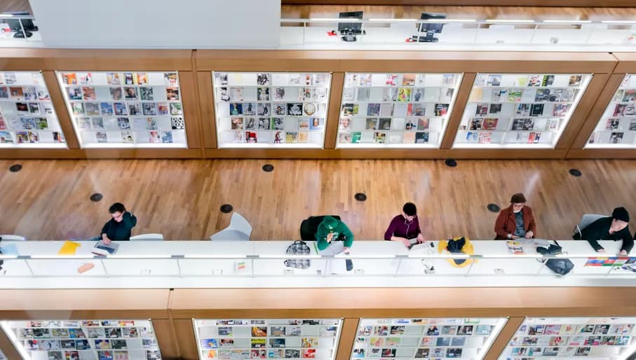 Amsterdam, the Netherlands - March 12, 2014: people, student are reading or working on the computers inside the modern central Public Library of Amsterdam, selected as best library of the Netherlands in 2012.