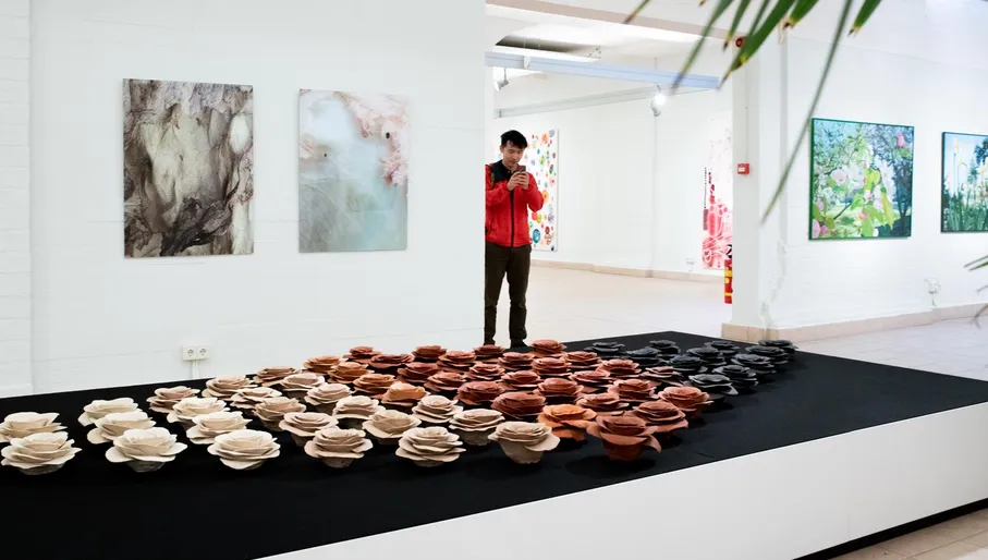 A visiter takes a picture of the art in Flower Art Museum Aalsmeer