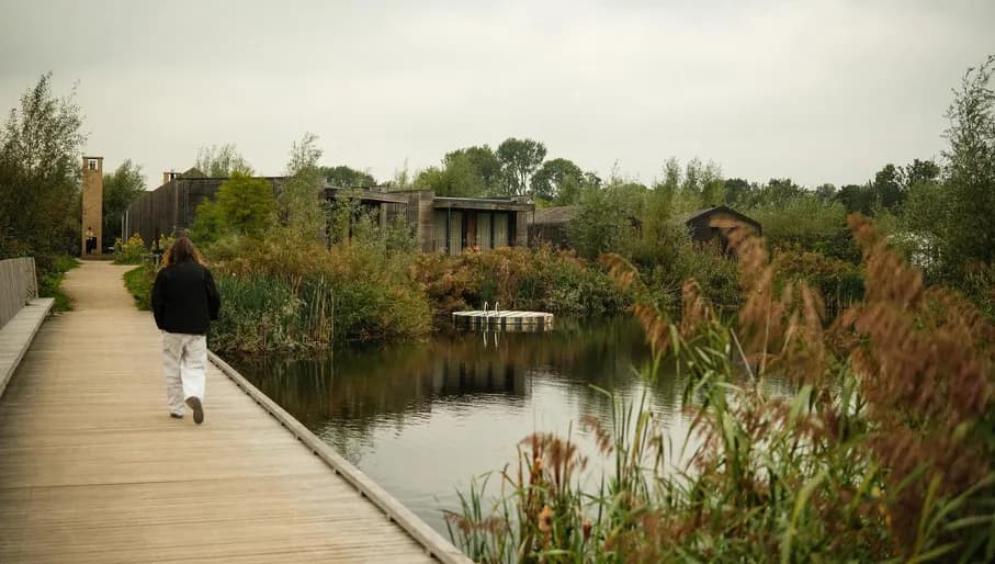 Man walking across bridge on the Unbound property