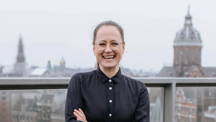 Referral Factory founder Kirsty Sharman smiling with central Amsterdam in background.
