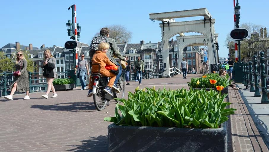 People walking and cycling over the  Magere Bridge
