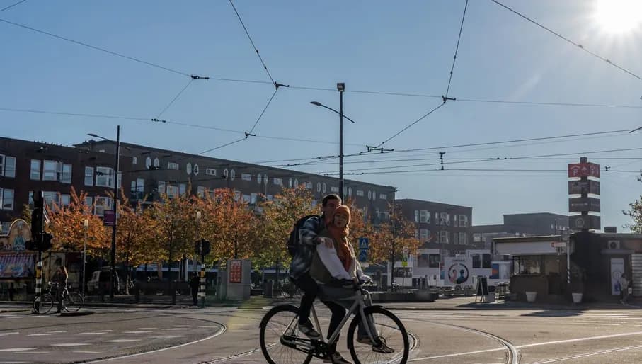 A person is cycling across the street at Mercatorplein.