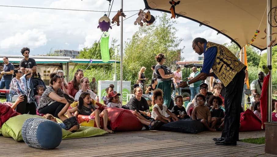 Children listening to a kids story at Kwaku Summer Festival 2023.