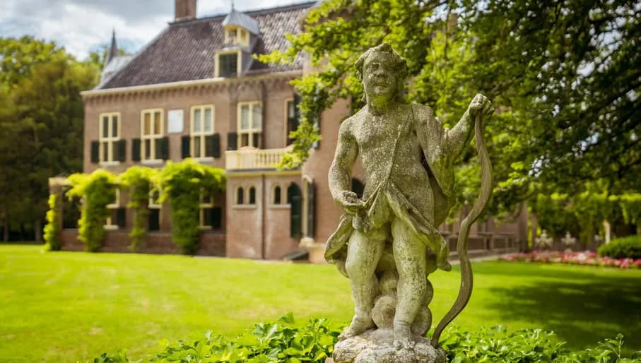 Statue of Cupid in the garden of Keukenhof Castle.