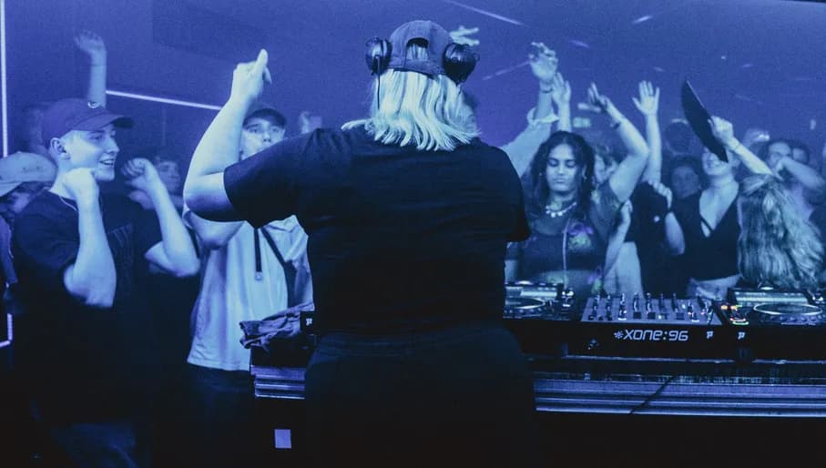 Club3 DJ playing and people dancing