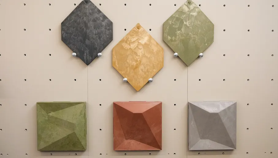 Colorful waste-based tiles displayed on a wall