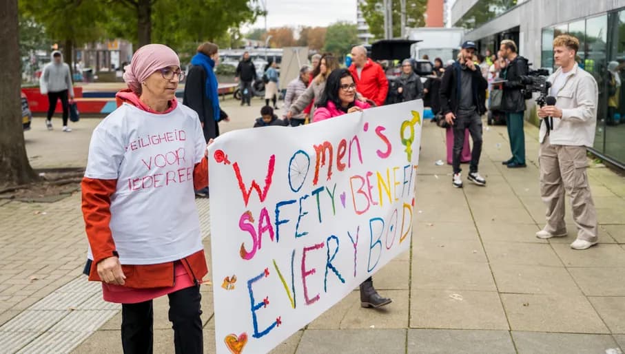 A couple holding a banner at the women's march