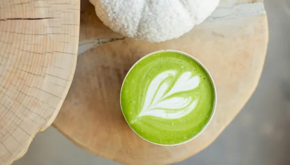 Matcha latte and wood plank