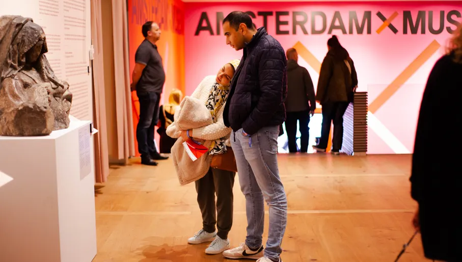 Couple checking out the Panorama Amsterdam exhibition at Amsterdam Museum in 2022