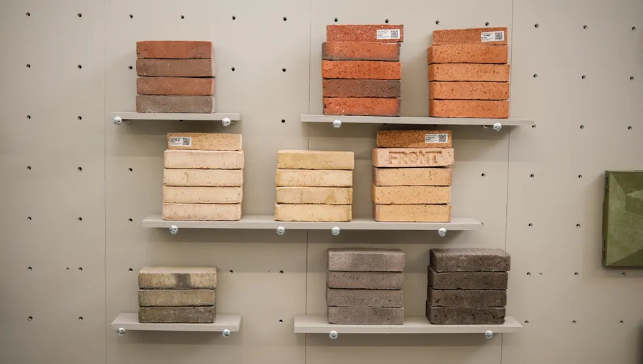 Stacks of colourful bricks, made from waste, displayed on a wall. From the FRONT offices.
