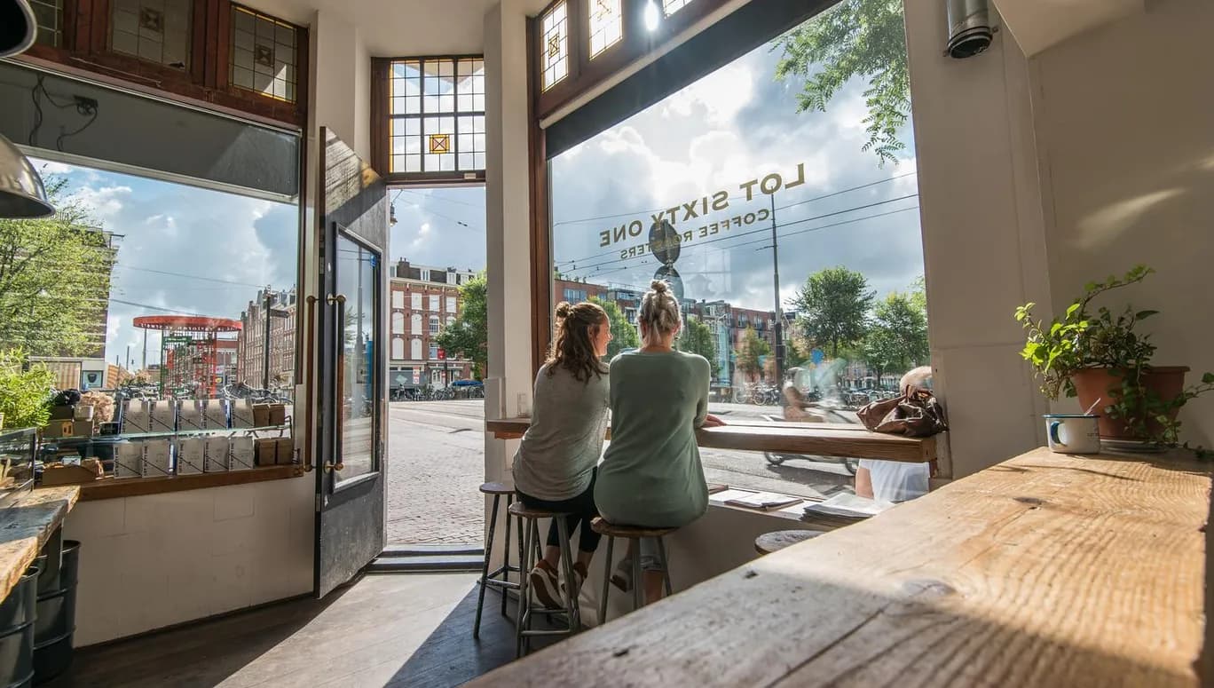 People looking out the window at Lot Sixty One Lot 61 coffee bar on the Kinkerstraat