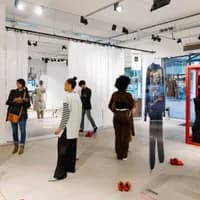 People looking at clothes at the new normal gallery