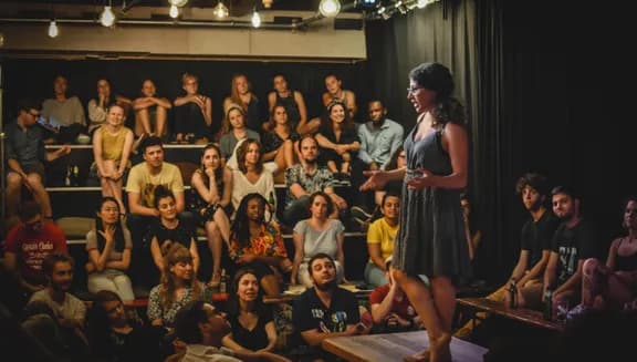 Speaker storytelling on stage at Mezrab