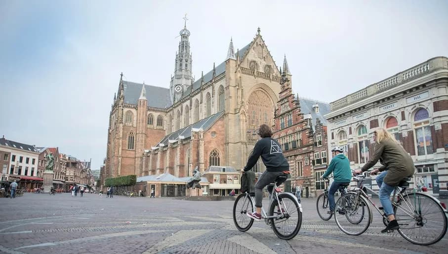 People biking over the Grote Markt of Haarlem.